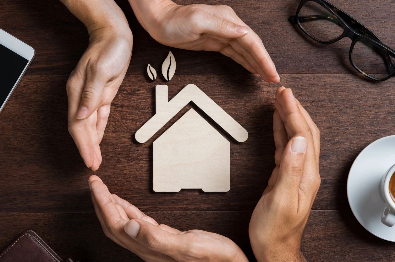 Hands surrounding a house