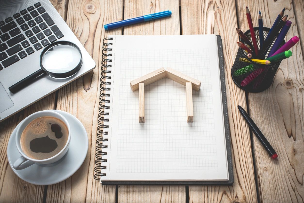 A wooden house on a notebook